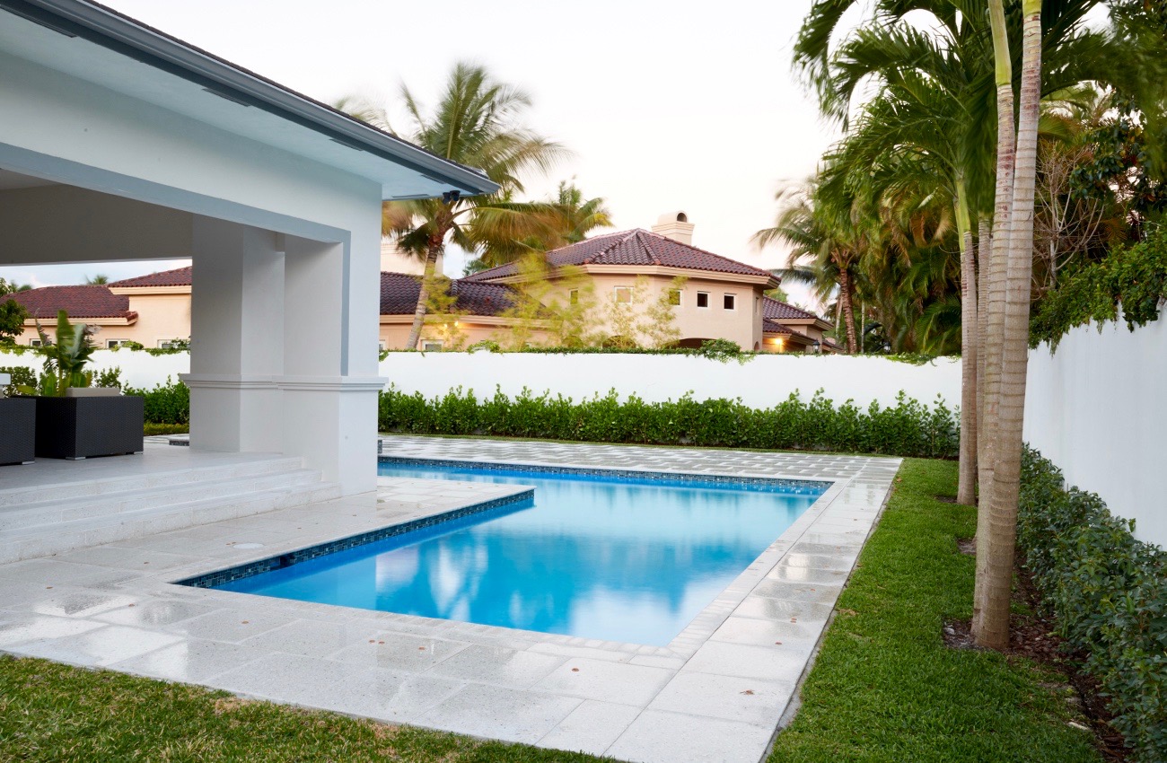 A pool that is in the middle of some grass.